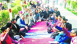 Teaching and non-teaching staff of Lajpat Rai DAV College hold a protest on its premises in Ludhiana