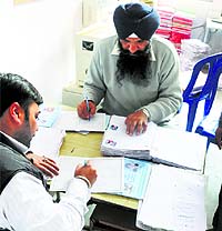 Government schoolteachers busy with data entry work for the Atta-Dal Scheme in Ludhiana