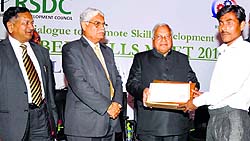 Madan Mohan Mittal, Minister of Industries and Commerce, Punjab, presents a certificate to a trainee during the Rubber Skills Meet-2014 in Ludhiana on Thursday