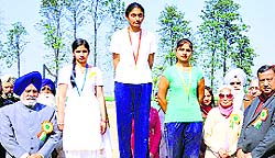 Organisers felicitate students of the Shanti Tara College for Women who excelled in the annual athletics meet at Akbarpur village