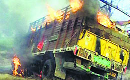 The burning canter on the Barnala-Bathinda highway near Ghunsan village in Barnala on Thursday.