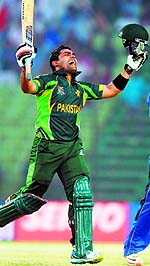 Umar Akmal celebrates after scoring a century on Thursday