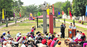 Mayor HC Kalyan addresses residents during the inauguration of a green belt at Sector 44 in Chandigarh on Friday.