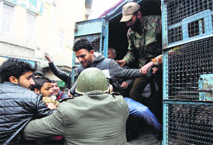 Protesters being detained by the police in Srinagar on Friday