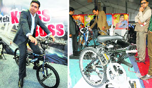 (Left) Gaurav Munjal, Managing Director, Hero EcoTech Ltd, poses with his newly launched cycles at the United India International Cycle Expo-2014 in Ludhiana on Friday; visitors look at a new-technology bike at the expo. Tribune photos: Himanshu Mahajan