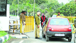 Security guards on duty at Gate No. 2 of Punjab Agricultural University in Ludhiana on Friday. Tribune Photo: Himanshu Mahajan