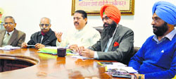 Rajesh Rudhra (second from left), president of the Association of Private Unaided Schools of Punjab, addresses a press conference in Ludhiana on Friday. Photo: Inderjeet Verma