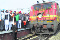 MP Sukhdev Singh Libra flags off a train at the Sirhind railway station on Friday. Tribune photo