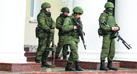 Armed men stand guard at the Simferopol airport in the Crimea region of Ukraine on Friday.