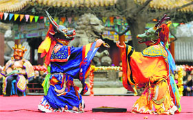 Monks dressed as Tibetan characters perform during a religious ceremony, known as Da Gui or beating ghost, to celebrate the Tibetan New Year which starts on March 1 at Yonghegong Lama Temple, in Beijing on Friday.
