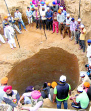 Volunteers dig out remains of martyrs from a well in Ajnala on Saturday.