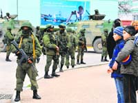 Armed men guard the streets of Simferopol in the Crimea region of Ukraine on Saturday