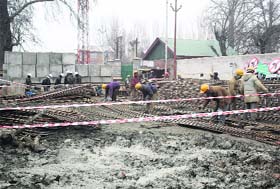 Labourers work on the Jehangir Chowk-Rambagh flyover in Srinagar