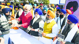 Damdami Taksal head Baba Harnam Singh Khalsa (right) and SGPC executive member Karnail Panjoli (second from right) release the book in Amritsar on Sunday.