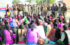 Women health workers block the highway at Lambi village in Muktsar on Sunday.