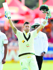 Michael Clarke raises his bat after reaching 150 for the 10th time in his career