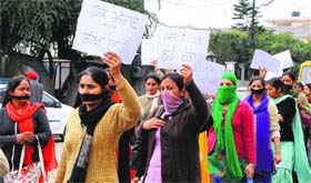 Contractual nurses and paramedical staff of GMC, Amritsar and Patiala, hold a protest march with their mouths covered in Amritsar on Monday