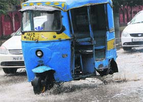 An auto-rickshaw in a rickety condition plying on a road in Amritsar