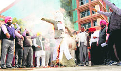 Members of the PUDA Employees Sangharsh Committee protest at Phase VIII in Mohali on Monday. A tribune photograph