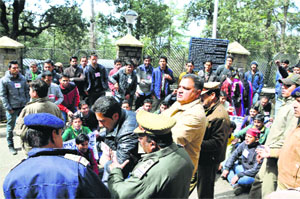 Cops manhandle activists of the SFI during a protest outside the VC's office at HPU in Shimla on Monday. 