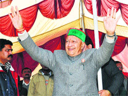 Chief Minister Virbhadra Singh waves at a crowd at Baldwara in Mandi on Monday