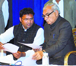 Chief Minister Bhupinder Singh Hooda and HPCC chief Ashok Tanwar (left) discuss a point at the party's general body meeting in Chandigarh on Monday.