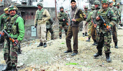 Army and police personnel in Pulwama after militants shot dead two policemen in the town on Monday. Tribune photo: Amin War