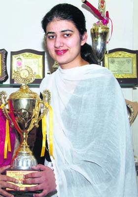 The winner of the All-India Debate Competition, Arshdeep Bains, with the trophy in Ludhiana