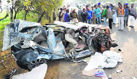 The remains of a car after its collision with a canter near Behman Dewana village in Bathinda on Monday.