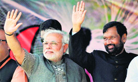 BJP Prime Ministerial candidate Narendra Modi and LJP chief Ram Vilas Paswan wave at the crowd during the Hunkar rally in Muzaffarpur in Bihar on Monday.