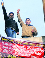 Two unemployed youths demanding jobs in Power Corporation climbed atop a water tank to lodge their protest against the government in Amritsar on Tuesday