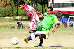 Players vie to take control of the ball in a match in the Narayan Gurung Memorial Football Tournament played at the Mahendra grounds in Dehradun on Tuesday