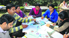 Government employees make blue cards at Red Cross Bhawan in Jalandhar on Tuesday. Photo: Sarabjit Singh