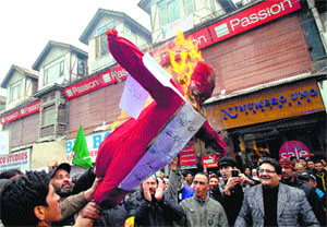 PDP supporters burn an effigy of Union Minister Farooq Abdullah in Srinagar on Tuesday.
