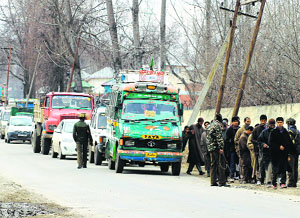 Policemen frisk passengers at a check point in Pulwama district on Tuesday. Two policemen were killed when militants attacked a police party outside a court complex in the district on Monday. 
