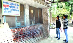 Visitors read a notice displayed at closed counters at the office of the Civil Surgeon in Ludhiana