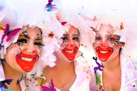 CLOWN REVELRY: A trio of revelers poses for a photo during the Clowns Parade in Lisbon