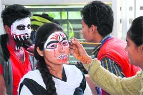 Gothic art: Students get final touches before a face painting contest during the inter-college competition Manthan 2014 at the SSD Womens Institute of Technology in Bathinda