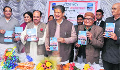 Chief Minister Harish Rawat releases a book on Tribes of Uttarakhand written by senior journalist Jai Singh Rawat in Dehradun on Tuesday evening. A tribune photograph 