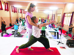 Participants in the International Yoga Festival being held at Pramarath Niketan in Rishikesh  on Tuesday. A Tribune photograph