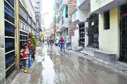Residents make their way through a water-logged road in Sector 7 of Faridabad. Photo: Rakesh Kashyap