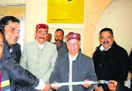 District president of the BJP Vinay Sharma presents a sword to party leader Shanta Kumar in Palampur on Wednesday