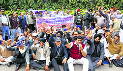Members of the All J&K Central Paramilitary Force Welfare Association protest in front of Exhibition Ground in Jammu on Wednesday