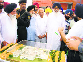 Chief Minister Parkash Singh Badal takes a look at a model of the proposed community health centre at Dehlon