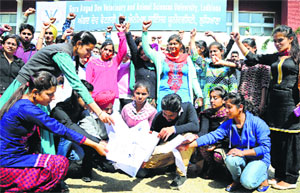 Students of the College of Dairy Science and Technology protest at Guru Angad Dev Veterinary and Animal Sciences University in Ludhiana on Wednesday