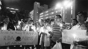 Medical students and junior doctors hold a candelight vigil at AIIMS in New Delhi against the police atrocity on doctors in Kanpur.