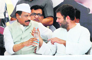 Congress vice-president interacts with a party leader in Aurangabad on Wednesday.