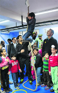 Jeev Milkha Singh watches a child climb a rope after inaugurating the fitness centre at the Chandigarh Golf Range on Thursday.