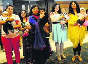 Mothers pose with their children during a fashion show in Chandigarh on Thursday.