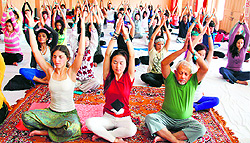 Yoga practitioners from 51 countries practice yoga asanas at Parmarth Niketan in Haridwar on Thursday
